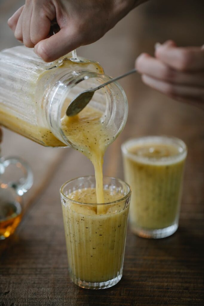 pexels-photo-5947107-5947107 Refreshing kiwi smoothie being poured into a glass, capturing the essence of a vibrant, healthy beverage.