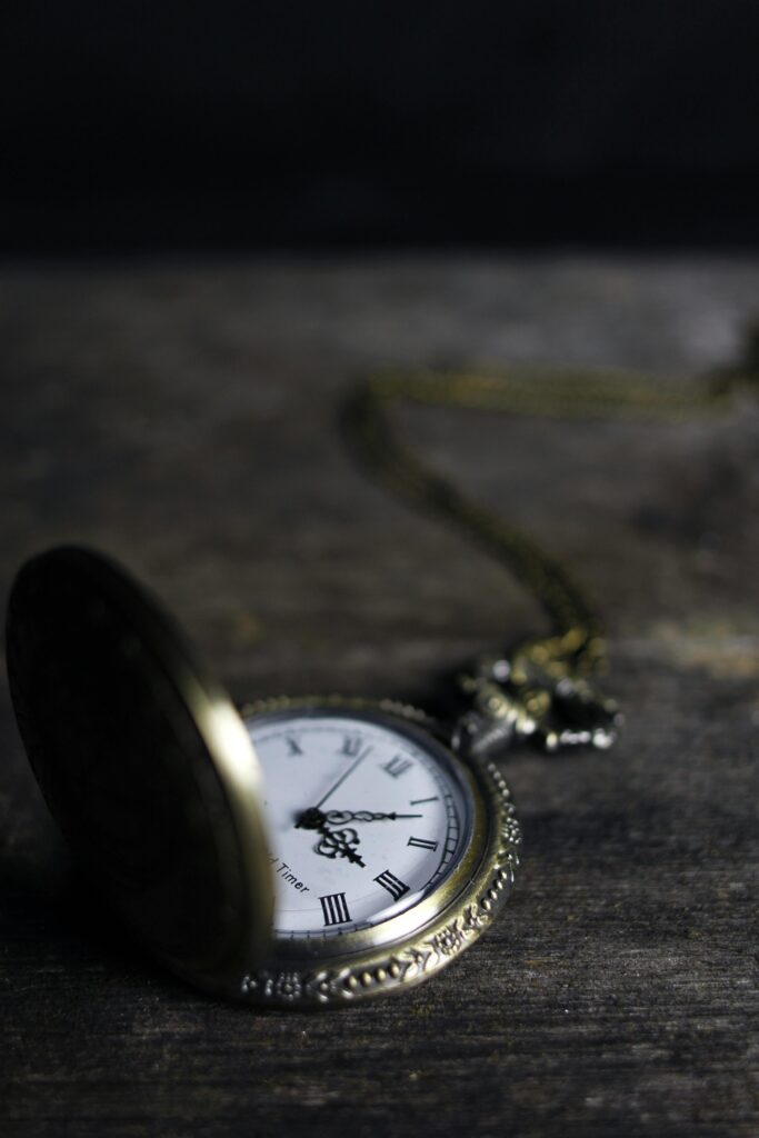 pexels-photo-277290-277290 Close-up of an ornate vintage pocket watch on a wooden surface, exemplifying timeless elegance.