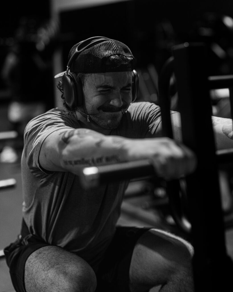 pexels-photo-33185464-33185464 Determined man exerting effort during intense gym workout in black and white photo.