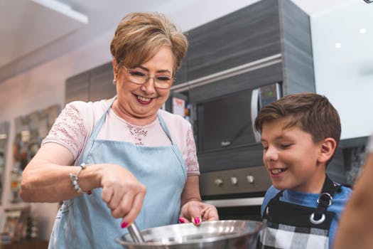 pexels-photo-8064878-8064878 Senior woman and young boy enjoying cooking together in a modern kitchen setting.