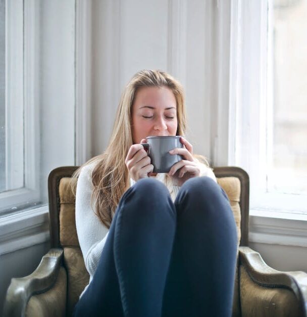 pexels-photo-846080-846080 Woman enjoying a warm drink in a cozy armchair by a window, embracing relaxation. relaxing hobbies