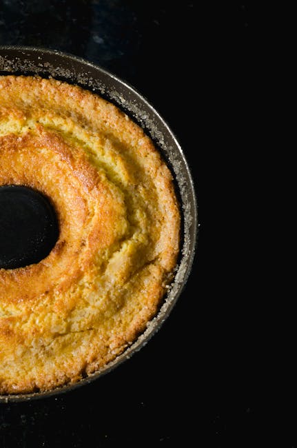 pexels-photo-940842-940842 Close-up of a delicious homemade bundt cake with a golden crust against a dark background.