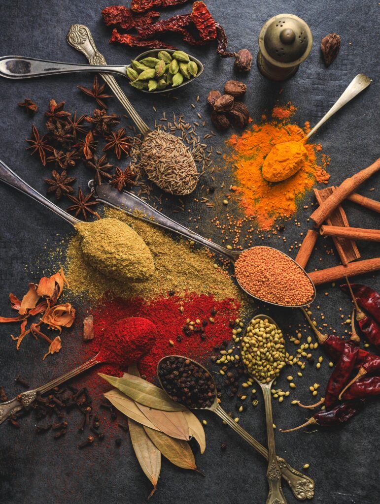 pexels-photo-2802527-2802527 Temperos Vibrant array of spices including turmeric, cumin, and chili arranged on a dark surface.