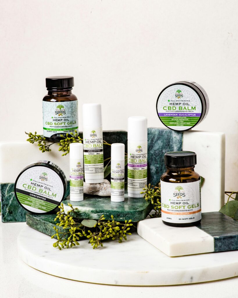 pexels-photo-3465383-3465383 Temperos An assortment of CBD products including balms and softgels arranged on a marble stand.